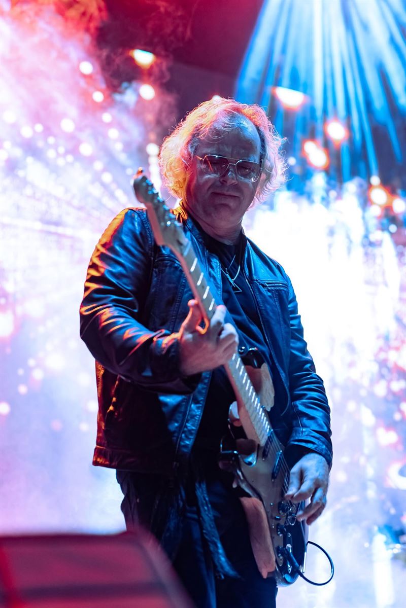 Guitarist playing under dramatic stage lights