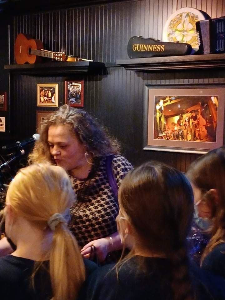 Singer sharing a moment with guests during a pub night