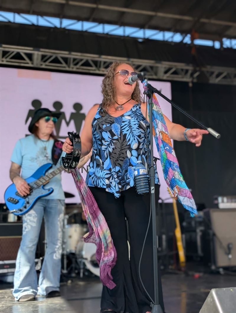 Lead singer performing at an outdoor festival