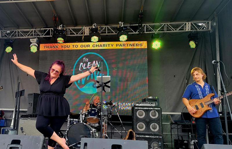 Singer dancing on stage at a charity festival